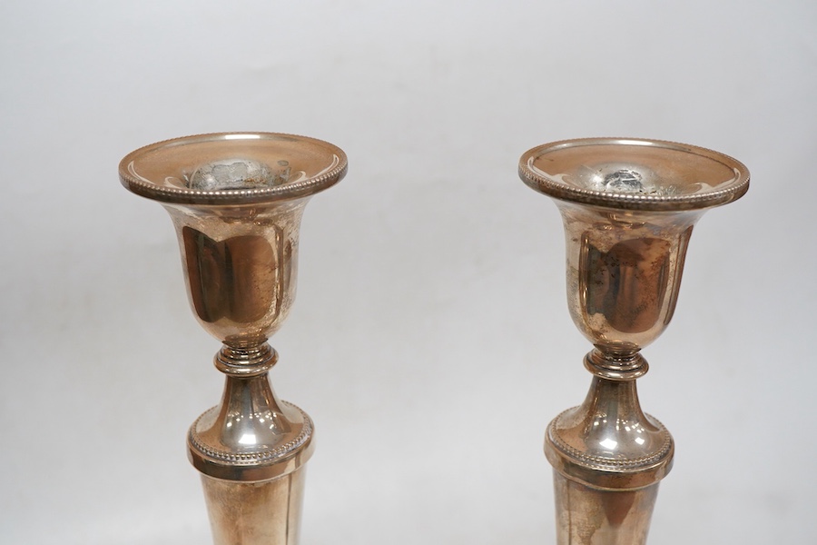 A pair of Elizabeth II silver candlesticks, with tapering stems, on circular foot, Broadway & Co, Birmingham, 1993, height 27cm, loaded.